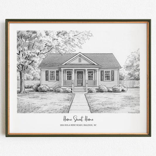 Framed black and white drawing of a house with trees and a garden on a white background